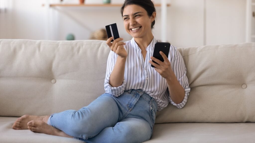 a woman holding her credit card
