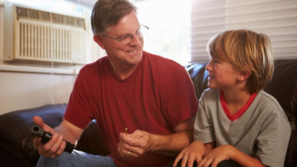 a man teaching son about firearms