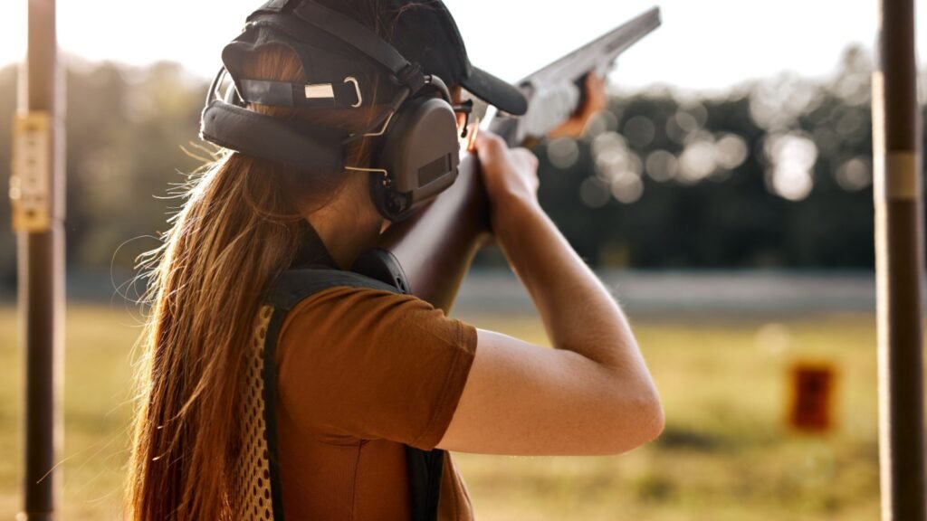 a woman practicing her shooting skills with a rifle
