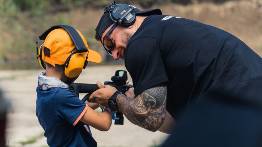 an instructor teaching kid about firearms