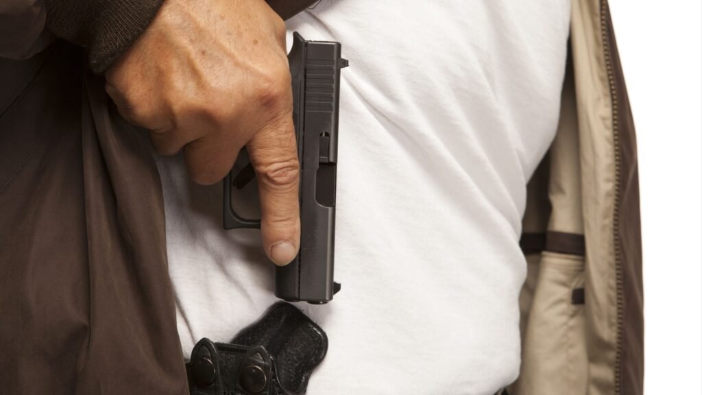 a man with a concealed carry handgun
