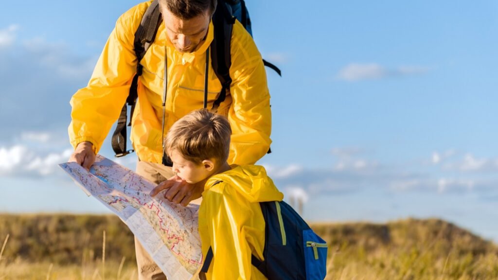 A dad showing a map with his son
