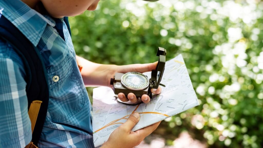 a man holding a map and compass
