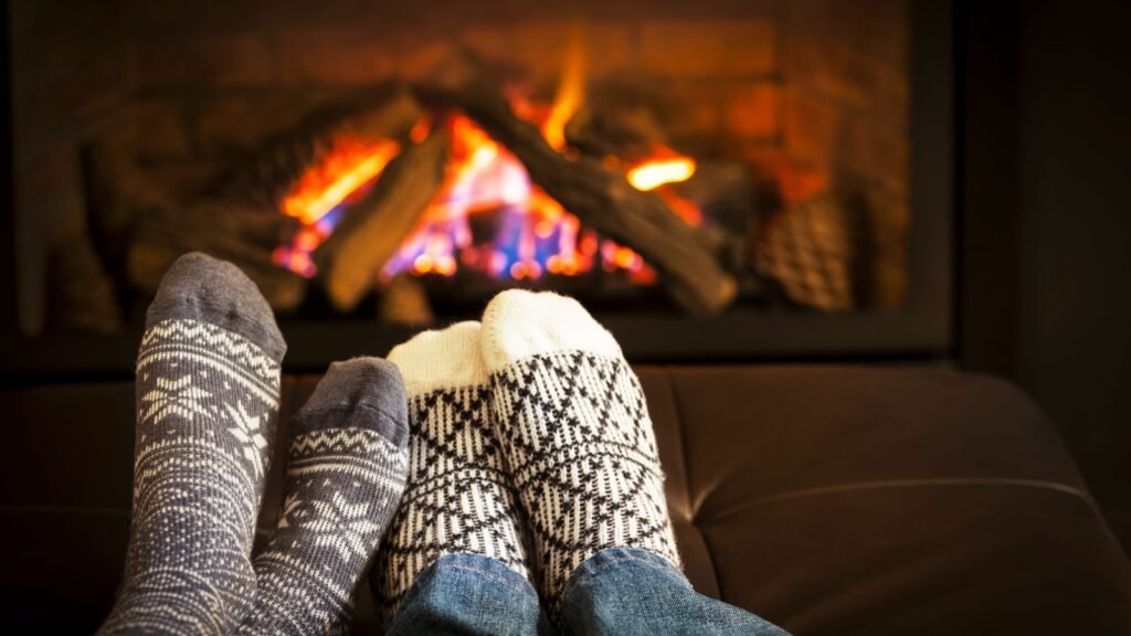 wearing socks near a fireplace
