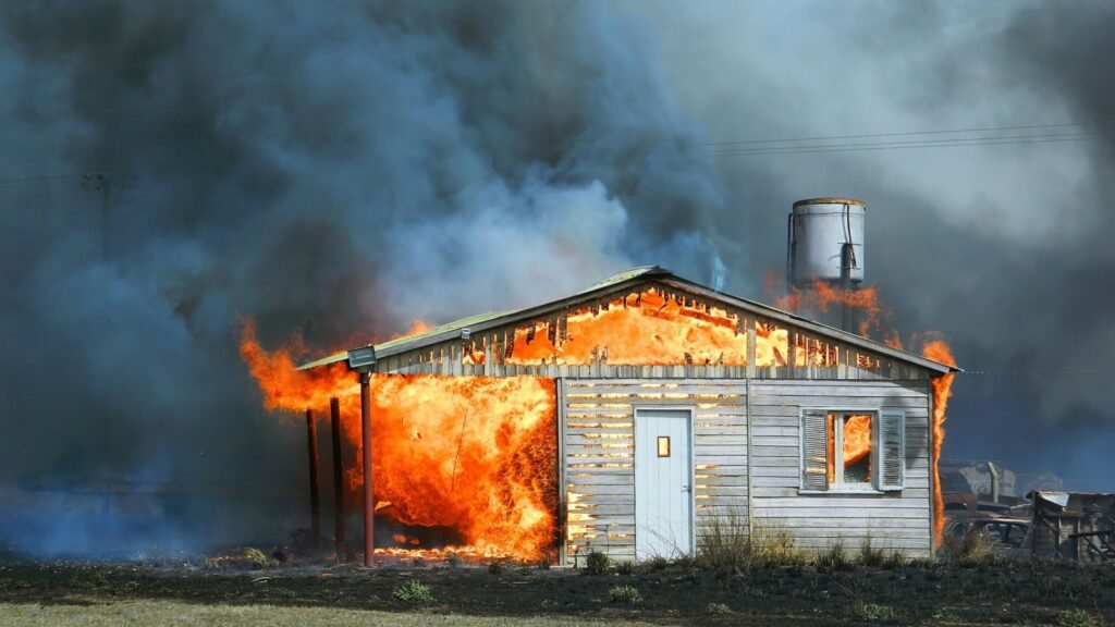 burning house in the field
