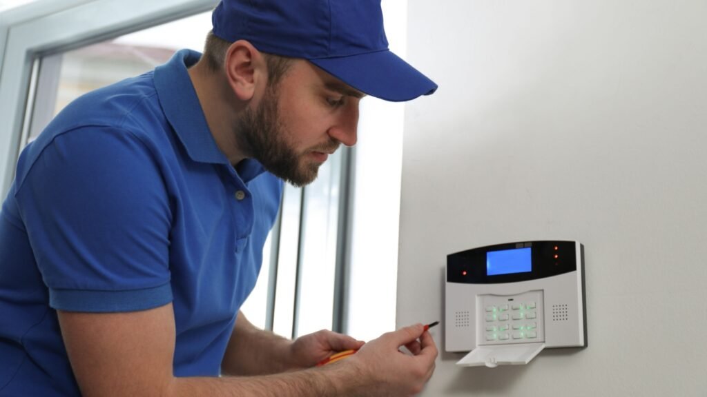 a man installing security alarm
