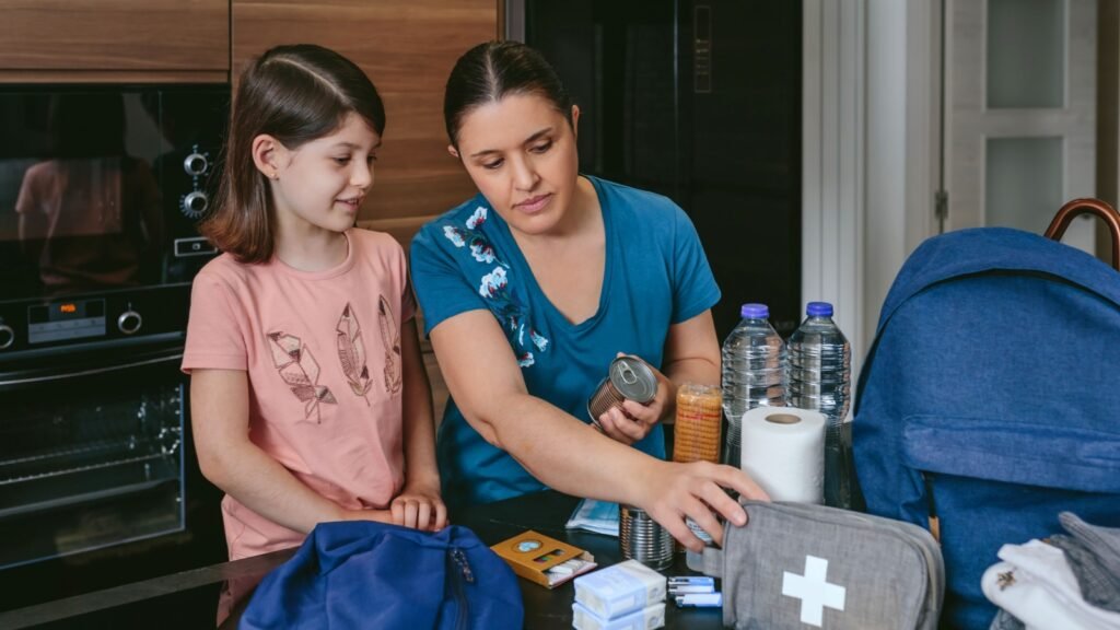 mother preparing go-bag with daughter
