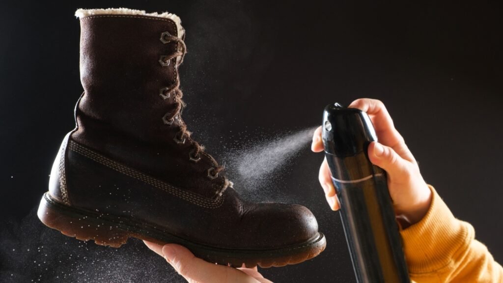 spraying water repellent to boots
