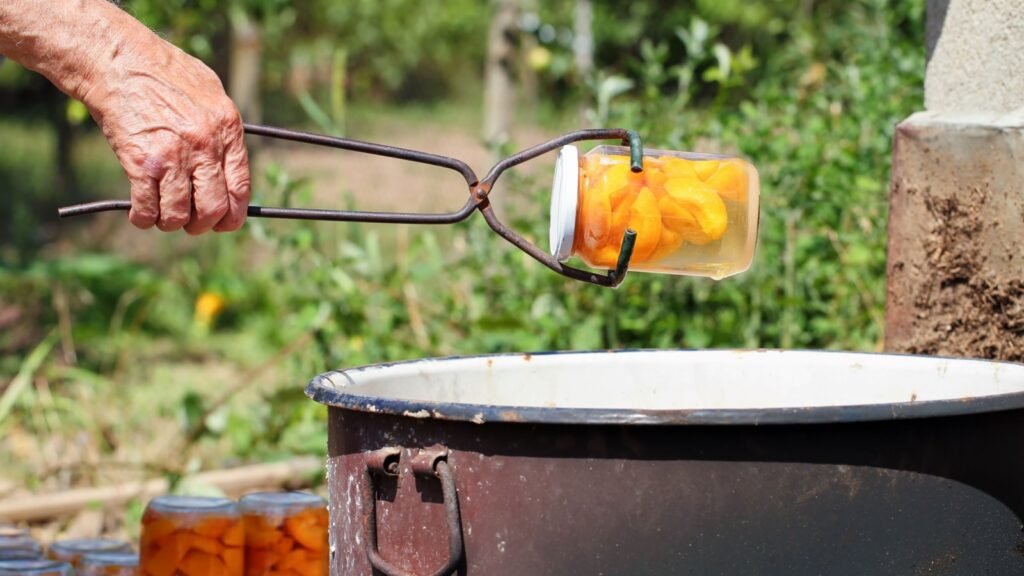 a man holding an old canning lifter