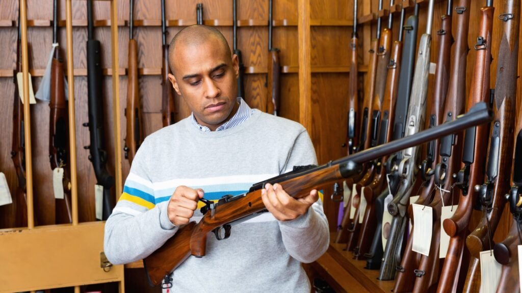 a man inspecting a hunting rifle