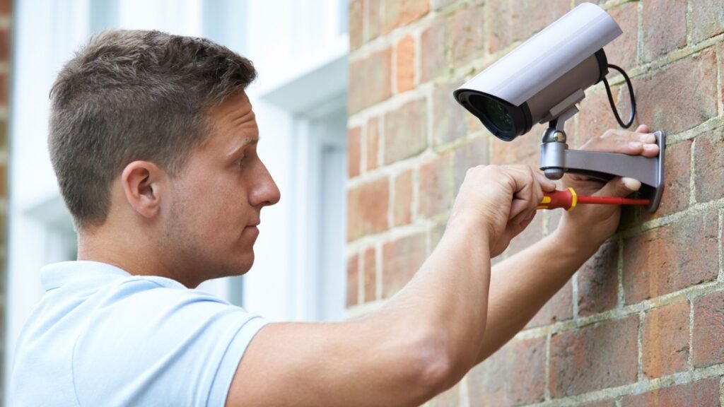 a man installing surveillance camera
