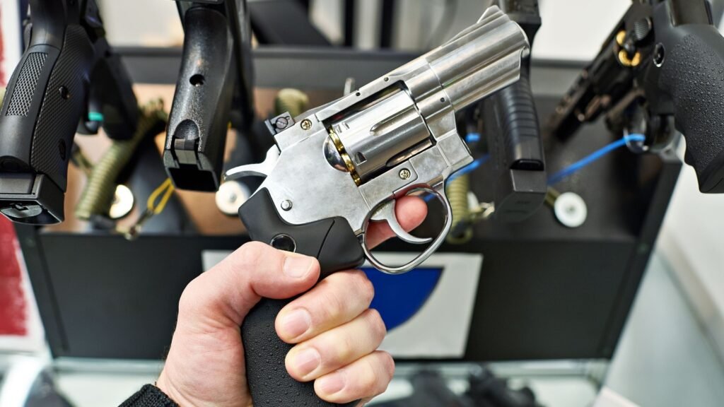 holding a revolver