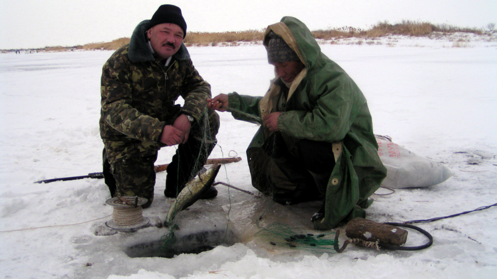 two fishermen ice fishing