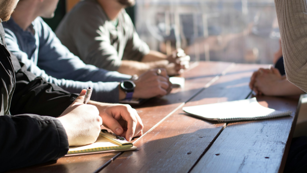 People sitting on chair taking notes