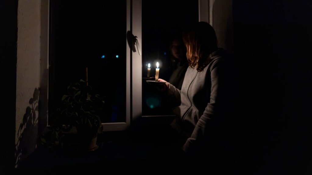 woman holding candle during a power outage