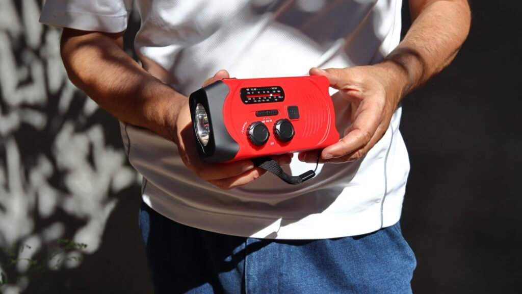 man holding an emergency portable radio