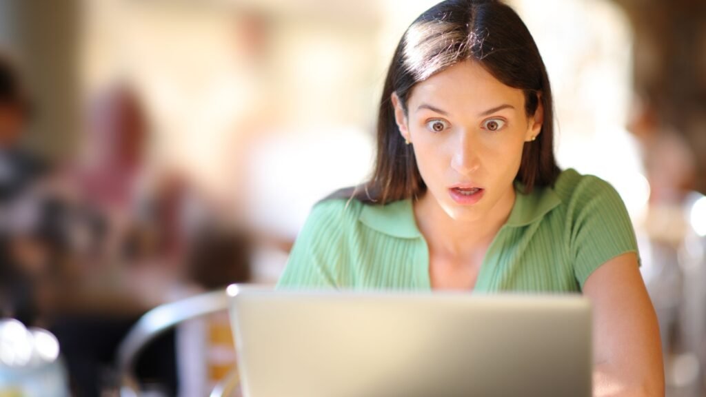 a stunned woman researching local natural disaster risks on a government website