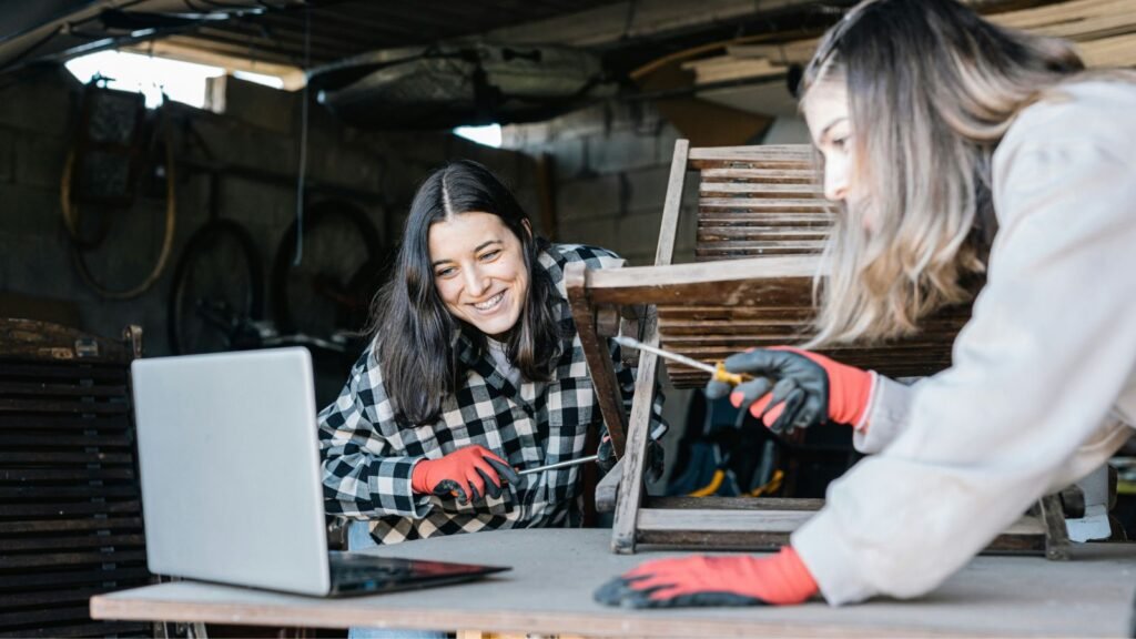 girls watching instructions on woodworking