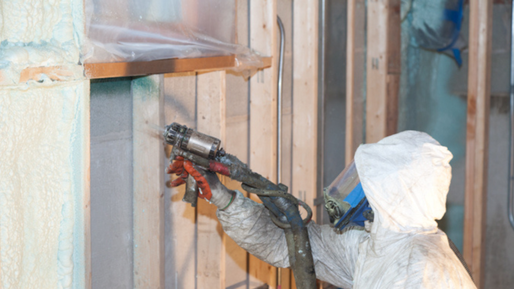 man applying spray foam