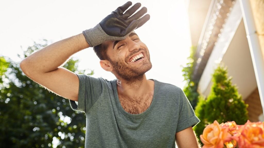 man smiling while gardening