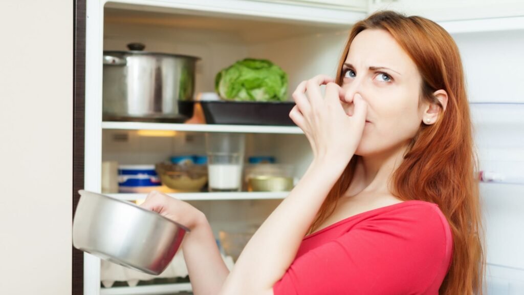 woman smelling spoiled food