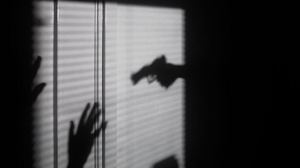 shadow of held at gunpoint